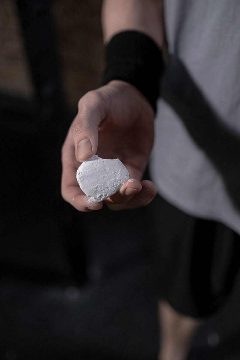 A block of lifting chalk held in a hand