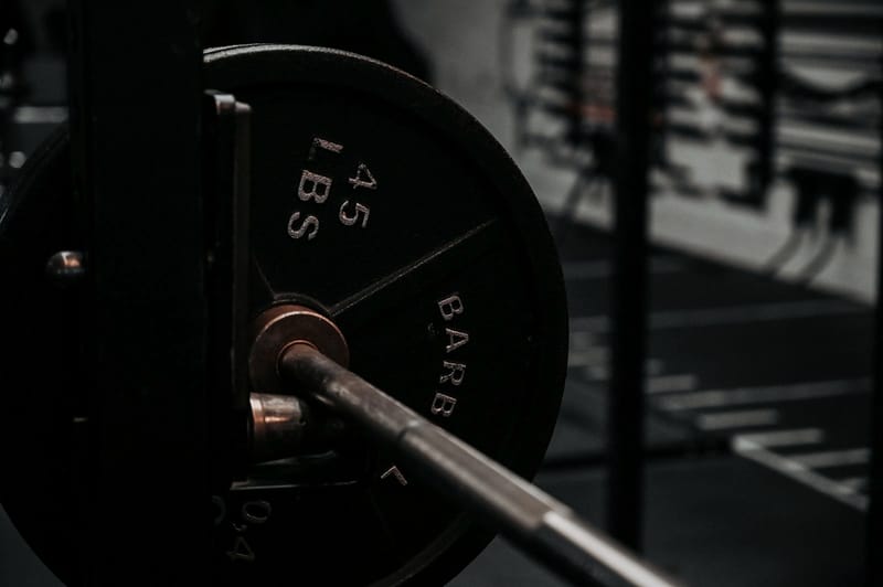 A 45 pound plate loaded on a knurled barbell sleeve
