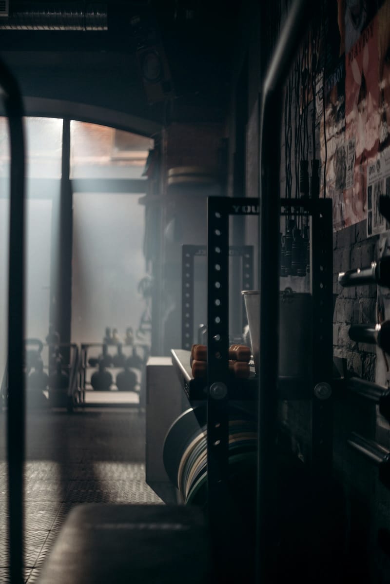 A dim gym interior with window light falling across the floor